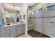 Bathroom with glass shower, gray tiles, and a double sink vanity at 530 Spaniards Rd, Placida, FL 33946