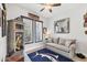 Cozy bedroom with neutral colors, a large window, and nautical decorations throughout the room at 530 Spaniards Rd, Placida, FL 33946
