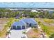 Gorgeous exterior of a single-Gathering home with a three-car garage and lush landscaping at 530 Spaniards Rd, Placida, FL 33946