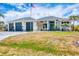 Beautiful home with mature landscaping and a blue front door at 530 Spaniards Rd, Placida, FL 33946