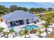 Beautiful in-ground pool with patio seating, outdoor bar, and landscaping at 530 Spaniards Rd, Placida, FL 33946