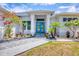Inviting front entrance with a beautiful blue front door and charming landscaping at 530 Spaniards Rd, Placida, FL 33946