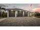 Spacious three-car garage with paver driveway and well-maintained landscaping at 530 Spaniards Rd, Placida, FL 33946
