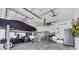 Spacious garage featuring a car lift, ceiling fan, lots of tool storage, and custom lighting at 530 Spaniards Rd, Placida, FL 33946