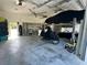 Open garage with lift for vehicle storage, shelving units and ample space at 530 Spaniards Rd, Placida, FL 33946