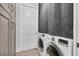 Bright laundry room features updated washer and dryer units with white door at 530 Spaniards Rd, Placida, FL 33946