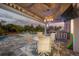 Outdoor patio with pool, bar, dining area and tropical landscaping at 530 Spaniards Rd, Placida, FL 33946