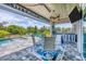 Outdoor patio featuring a bar, television, ceiling fans, and table and chair seating at 530 Spaniards Rd, Placida, FL 33946