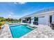 Beautiful blue in-ground pool with patio seating, outdoor bar, and landscaping at 530 Spaniards Rd, Placida, FL 33946