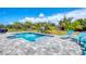 Beautiful blue in-ground pool with patio seating and landscaping at 530 Spaniards Rd, Placida, FL 33946