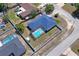 Captivating aerial view showcasing a home with a screened-in pool nestled in a fenced yard at 5510 Moongate Rd, Spring Hill, FL 34606