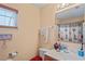 Bathroom with light-colored walls, window, white towels, shower curtain, toilet and single sink vanity at 5510 Moongate Rd, Spring Hill, FL 34606