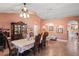 Elegant dining room featuring a decorative hutch, chandelier, and neutral tiling at 5510 Moongate Rd, Spring Hill, FL 34606
