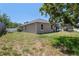 Charming exterior view showcasing a well-maintained lawn and a beautiful screened-in pool area at 5510 Moongate Rd, Spring Hill, FL 34606