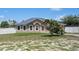 Charming single-story home with a manicured lawn and inviting curb appeal, fenced yard at 5510 Moongate Rd, Spring Hill, FL 34606