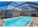 Enjoy this screened-in pool with a lounge area in the home's backyard at 5510 Moongate Rd, Spring Hill, FL 34606