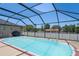 Relax and unwind in this screened-in pool with outdoor dining and grilling areas at 5510 Moongate Rd, Spring Hill, FL 34606