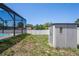 A storage shed with a view of the screened-in pool at 5510 Moongate Rd, Spring Hill, FL 34606