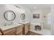 Bright bathroom with double vanities, undermount sinks, subway tile, and soaking tub at 59 White Marsh Ln, Rotonda West, FL 33947