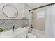 Stylish bathroom featuring black fixtures, decorative tile, a toilet, and a vanity at 59 White Marsh Ln, Rotonda West, FL 33947