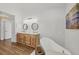 Bright bathroom with double vanities, undermount sinks, subway tile, and soaking tub at 59 White Marsh Ln, Rotonda West, FL 33947