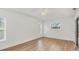 Bright bedroom with white ceiling fan, wood-look floors, and windows to the outside at 59 White Marsh Ln, Rotonda West, FL 33947