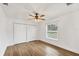 Bright bedroom with a ceiling fan, window, closet, and laminate wood flooring at 59 White Marsh Ln, Rotonda West, FL 33947