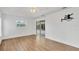 Bright bedroom with wood-look floors and sliding glass doors to the lanai at 59 White Marsh Ln, Rotonda West, FL 33947