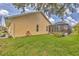 Lawn and side exterior view of home with screened in patio and lawn at 59 White Marsh Ln, Rotonda West, FL 33947