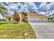 Charming single-story home with a three-car garage, a well-manicured lawn, and a bright, inviting facade at 59 White Marsh Ln, Rotonda West, FL 33947