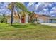 Single-story home featuring a well-maintained lawn, palm trees, and an inviting entrance, perfect for Florida living at 59 White Marsh Ln, Rotonda West, FL 33947