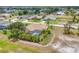 Rear exterior of the home with pool and lush tropical plants at 59 White Marsh Ln, Rotonda West, FL 33947