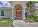 Inviting front entrance featuring a bright door, elegant columns, and lush landscaping, creating a warm welcome at 59 White Marsh Ln, Rotonda West, FL 33947