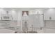 Modern kitchen featuring white cabinetry, stainless steel appliances, and a convenient walk-in pantry at 59 White Marsh Ln, Rotonda West, FL 33947