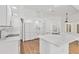 Bright, modern kitchen with white cabinets, a center island, stainless appliances, and wood-look flooring at 59 White Marsh Ln, Rotonda West, FL 33947