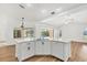 Open-concept kitchen island with white cabinets, quartz countertops, and view of the pool area at 59 White Marsh Ln, Rotonda West, FL 33947