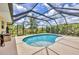 Enclosed in ground pool with a screened in patio and well maintained deck at 59 White Marsh Ln, Rotonda West, FL 33947