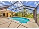 Screened in pool area with a well-maintained patio, lawn and landscaping at 59 White Marsh Ln, Rotonda West, FL 33947
