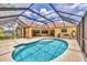 Screened in pool and patio area with a view into the home's interior at 59 White Marsh Ln, Rotonda West, FL 33947