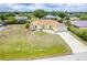 Aerial view of a cozy single-Gathering home in a lush, green neighborhood with mature trees at 6158 Cavan St, Englewood, FL 34224