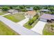 Aerial view of a cozy single-Gathering home in a lush, green neighborhood with mature trees at 6158 Cavan St, Englewood, FL 34224