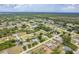 An aerial view showcasing the property's position within a sprawling, green residential neighborhood at 6158 Cavan St, Englewood, FL 34224