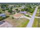 Aerial view of a well-maintained property surrounded by a lush lawn and mature landscaping in a quiet neighborhood at 6158 Cavan St, Englewood, FL 34224