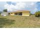 Wide backyard view includes lawn, the house, shed, and landscaping at 6158 Cavan St, Englewood, FL 34224