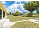 Spacious backyard with patio area, lush lawn, and established trees at 6158 Cavan St, Englewood, FL 34224