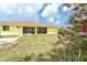 Well-maintained backyard with patio, grass, trees and blooming shrubbery at 6158 Cavan St, Englewood, FL 34224