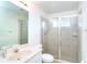 Bathroom featuring a shower with glass doors, tile surround, vanity, and a large mirror at 6158 Cavan St, Englewood, FL 34224