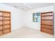 Bright bedroom featuring neutral carpet, a ceiling fan, and light-filled window in a staged setting at 6158 Cavan St, Englewood, FL 34224