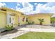 Close up of a well maintained single-story home featuring a welcoming front entrance with outdoor seating at 6158 Cavan St, Englewood, FL 34224