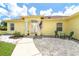 Charming single-story home featuring a welcoming front entrance with decorative columns and outdoor seating at 6158 Cavan St, Englewood, FL 34224